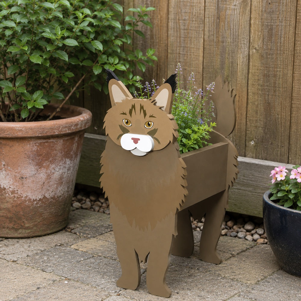 Maine Coon cat planter filled with fresh flowers is placed in the garden