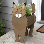 Maine Coon cat planter filled with fresh flowers is placed in the garden