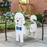 Maltese dog planter filled with fresh flowers is placed in the garden