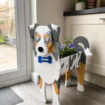Blue Merle Border Collie dog planter filled with fresh flowers is placed in the room