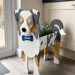 Blue Merle Border Collie dog planter filled with fresh flowers is placed in the room