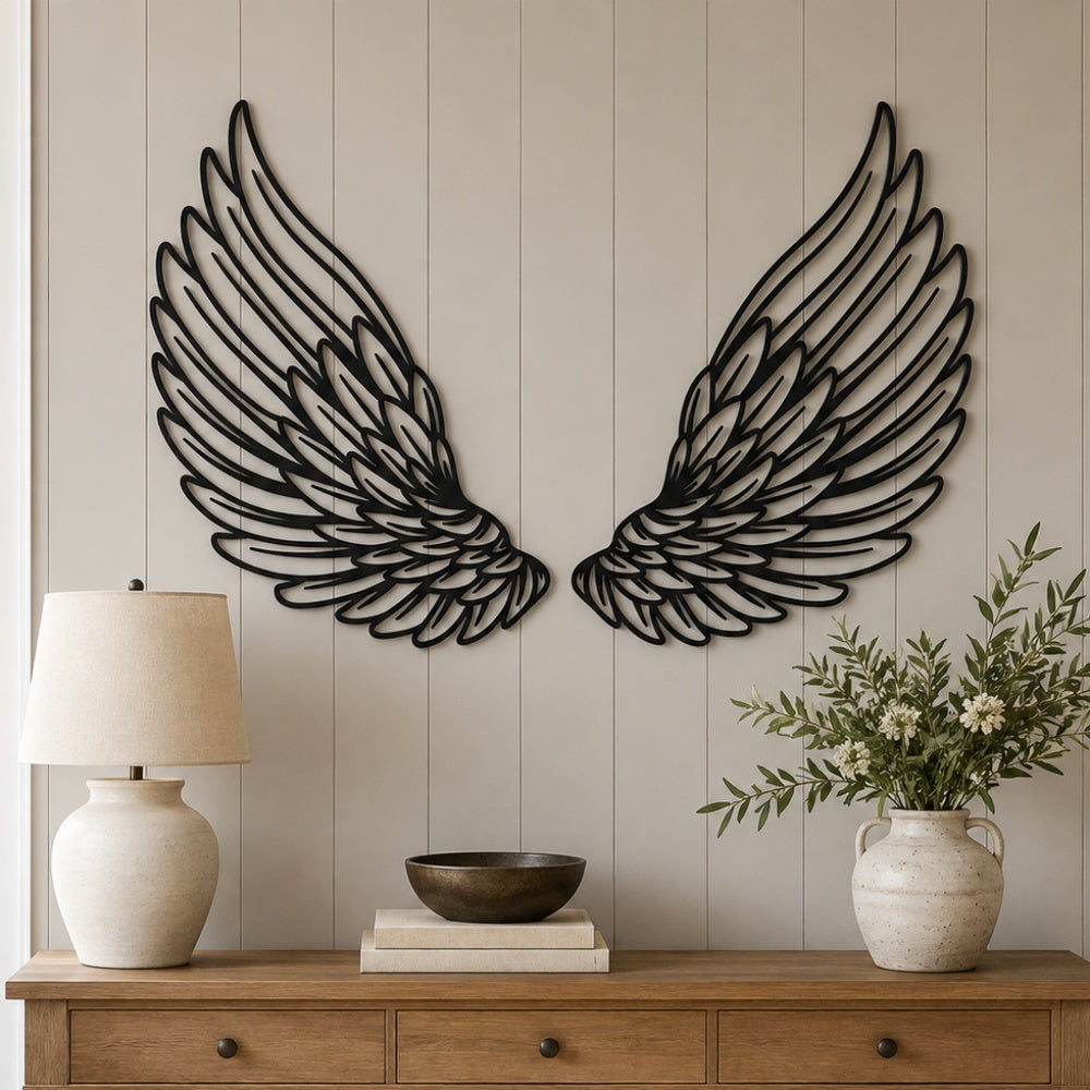 Black Metal Angel Feather Wings Wall Art with Intricate Cutout Details displayed on a beige paneled wall