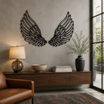 Black metal angel feather wings wall art mounted on a textured gray wall  in a modern living room setting