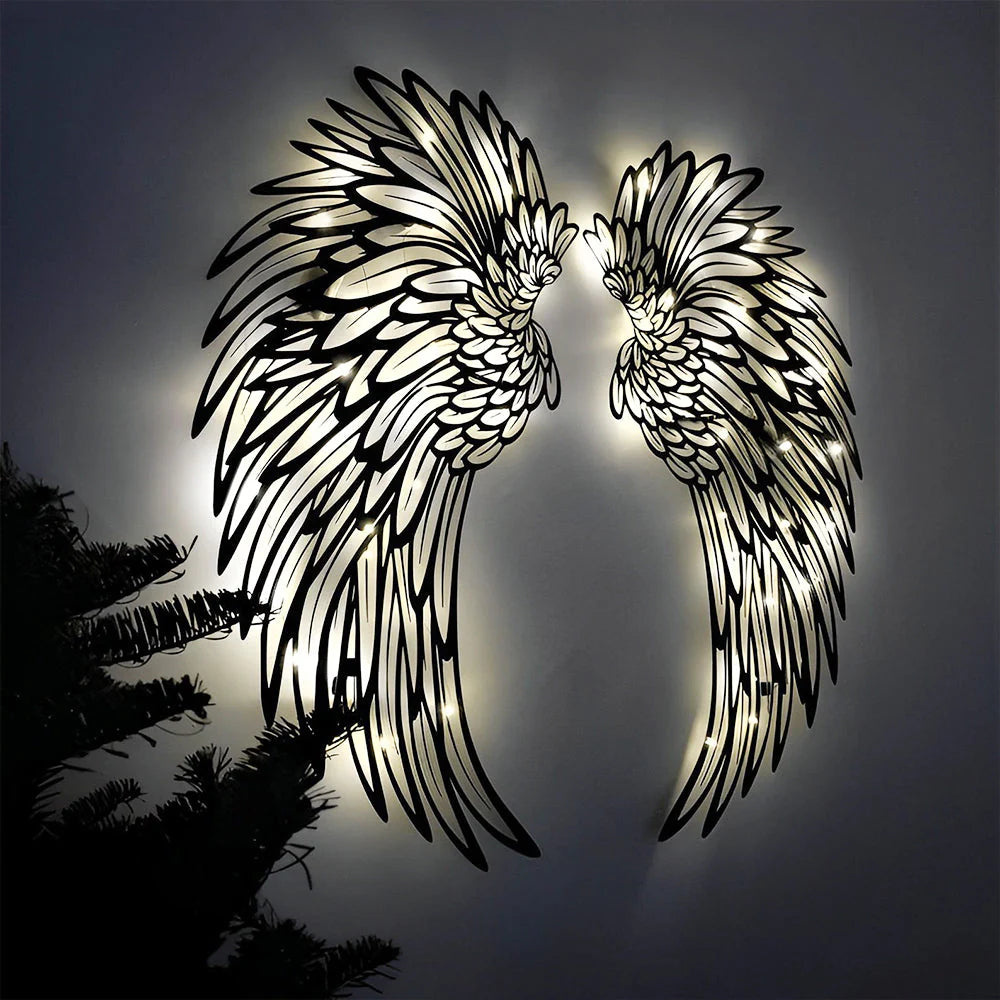 Black metal angel wings wall art displayed on a living room wall