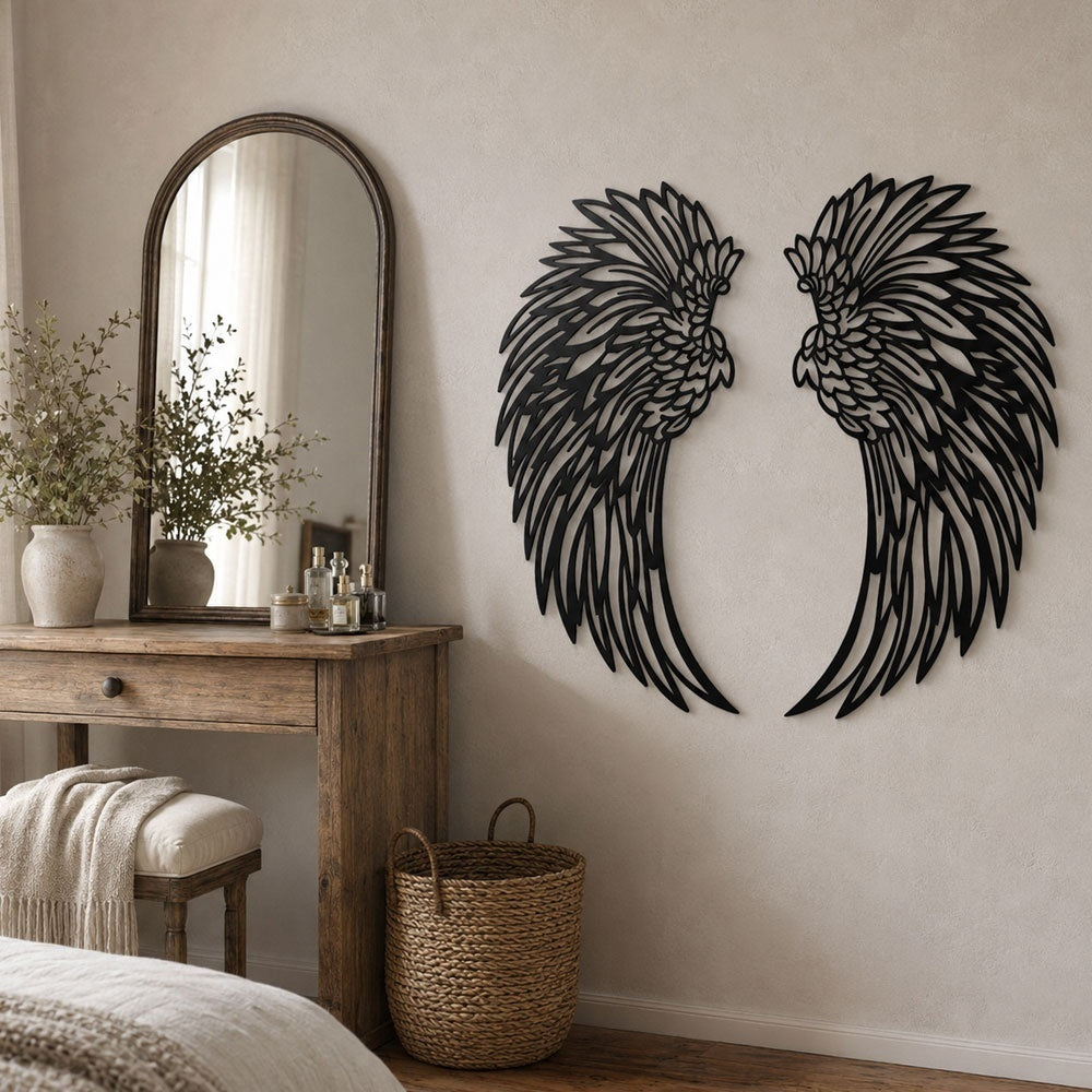 Black metal angel wings wall art displayed on a living room wall