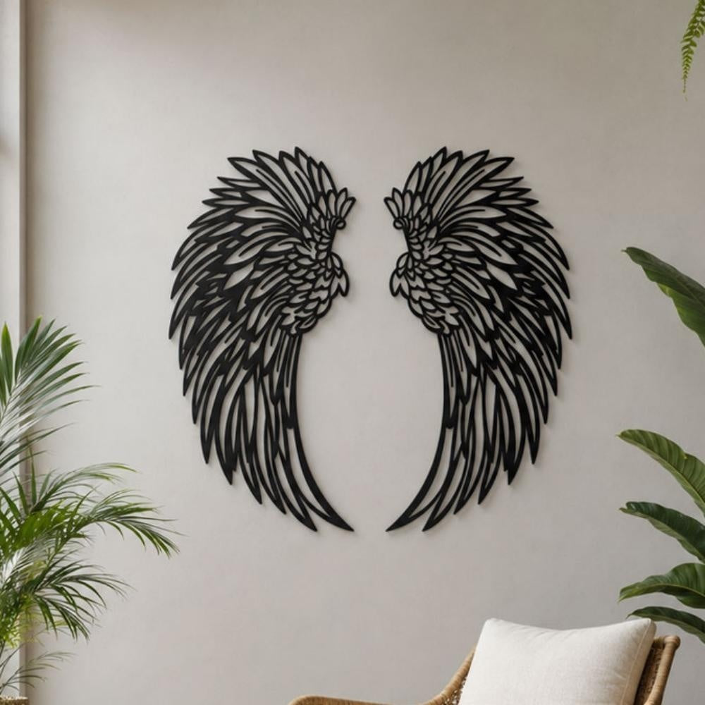 Black metal angel wings wall art displayed on a living room wall