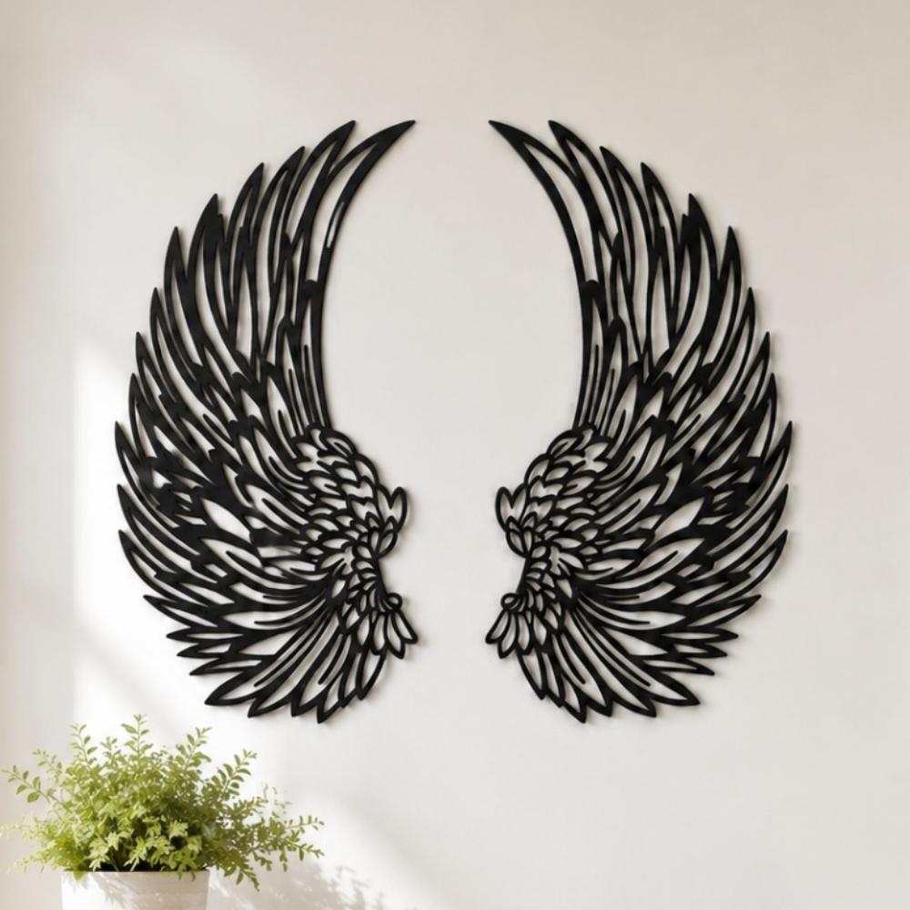 Black metal angel wings wall art displayed on a living room wall