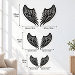 Black metal Angel wings wall art with intricate cutout details displayed on the wall