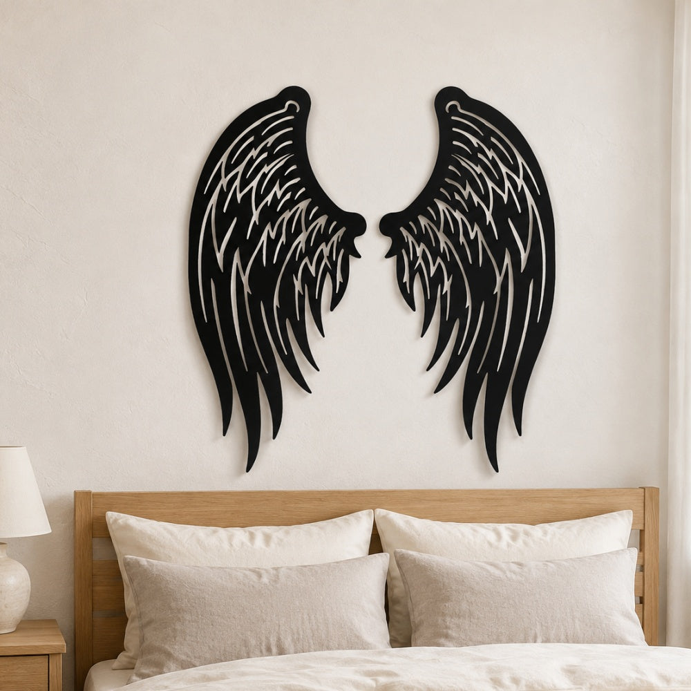 Black metal Angel wings wall art with intricate cutout details displayed on the wall