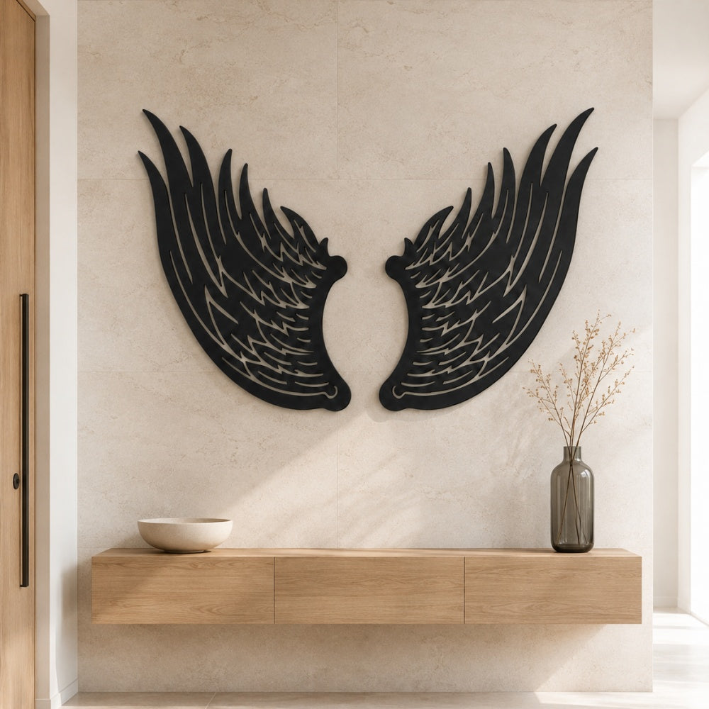 Black metal Angel wings wall art with intricate cutout details displayed on the wall