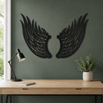 Black metal Angel wings wall art with intricate cutout details displayed on the wall