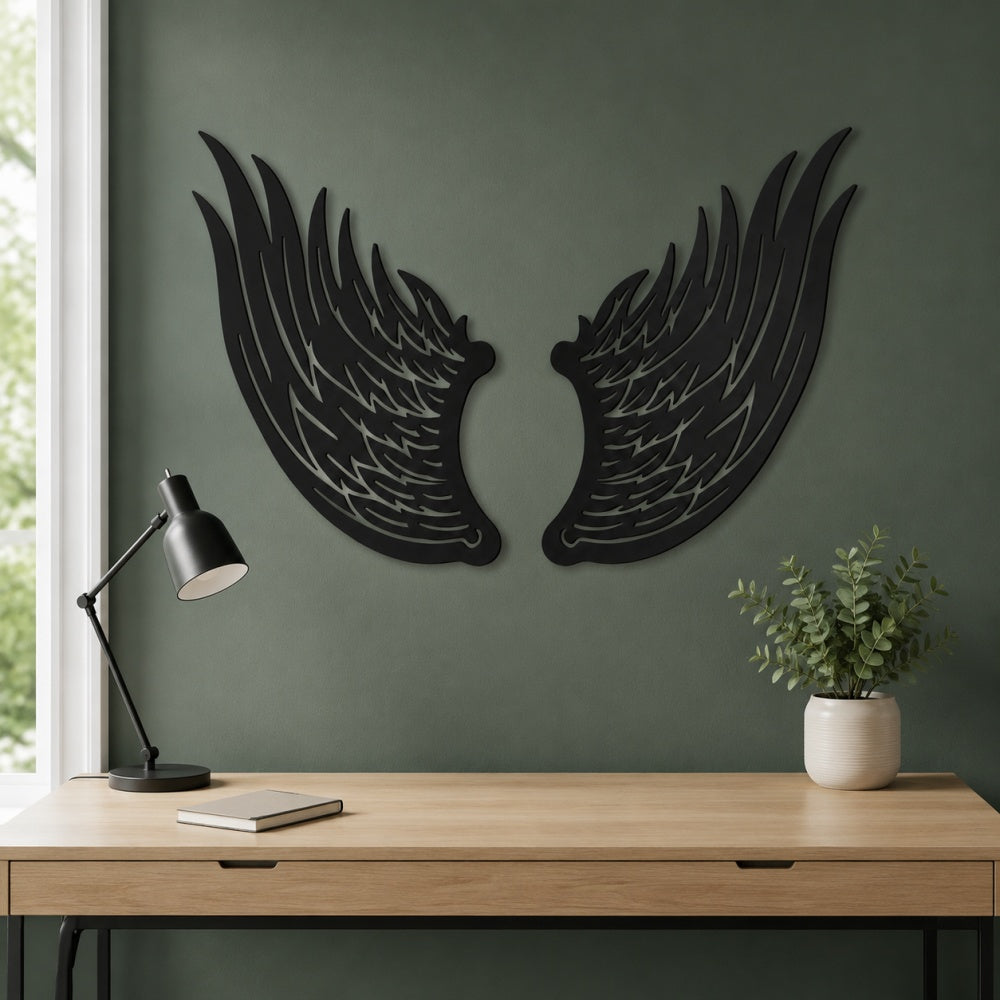 Black metal Angel wings wall art with intricate cutout details displayed on the wall