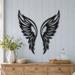 Black metal Butterfly wings wall art with intricate cutout details displayed on the wall