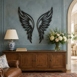 Black metal Butterfly wings wall art with intricate cutout details displayed on the wall