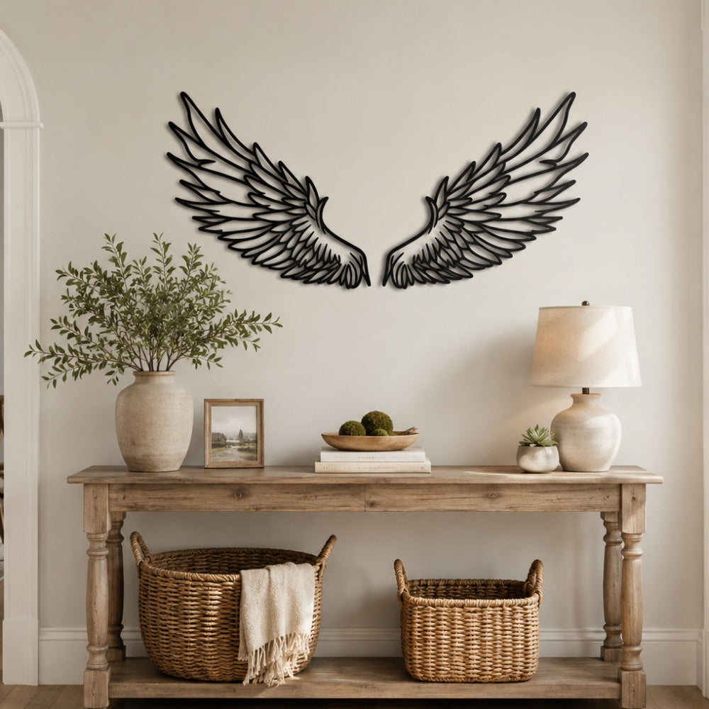 Black metal Celestial Angel wings wall art with intricate cutout details displayed on the wall