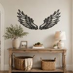 Black metal Celestial Angel wings wall art with intricate cutout details displayed on the wall