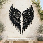 Black metal Flame Style Angel wings wall art with intricate cutout details displayed on the wall