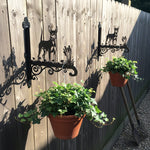 Miniature pinscher metal hanging basket bracket mounted on outdoor wall for plant decoration