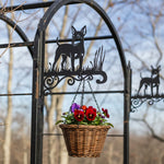 Miniature pinscher metal hanging basket bracket mounted on outdoor wall for plant decoration