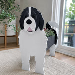 Newfoundland dog planter filled with fresh flowers is placed in the garden