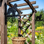 Newfoundland metal hanging basket bracket mounted on outdoor wall for plant decoration