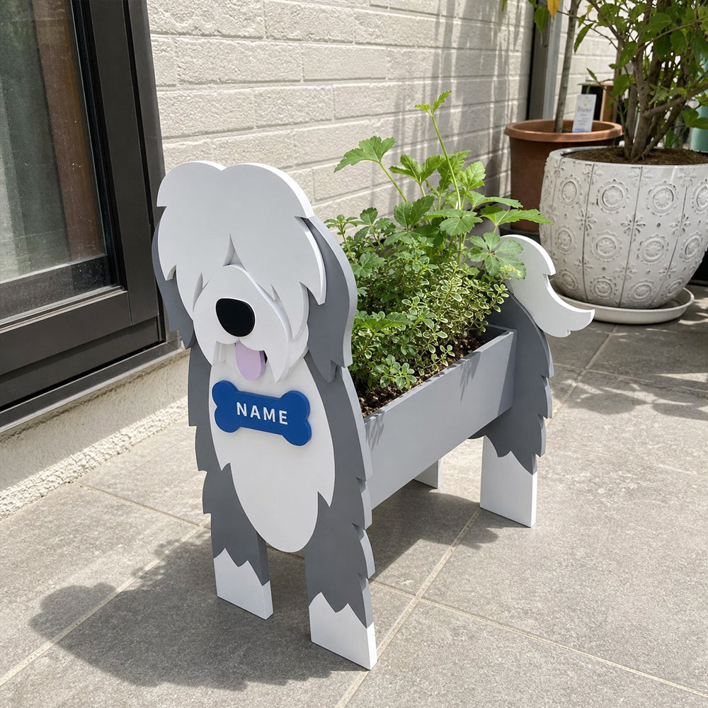 Old English Sheepdog  planter filled with fresh flowers is placed in the garden.