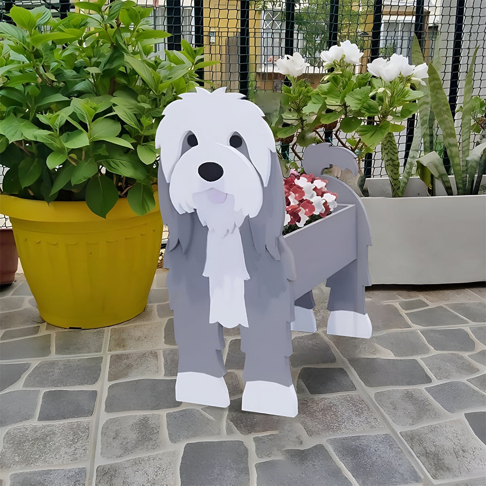 Old English Sheepdog  planter filled with fresh flowers is placed in the garden.