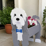 Old English Sheepdog  planter filled with fresh flowers is placed in the garden.