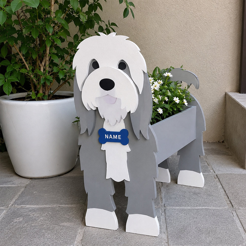 Old English Sheepdog  planter filled with fresh flowers is placed in the garden.