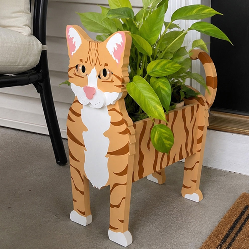 Orange Tabby cat planter filled with fresh flowers is placed in the garden
