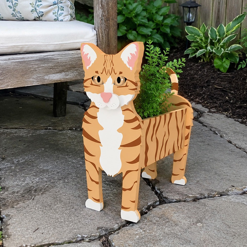 Orange Tabby cat planter filled with fresh flowers is placed in the garden
