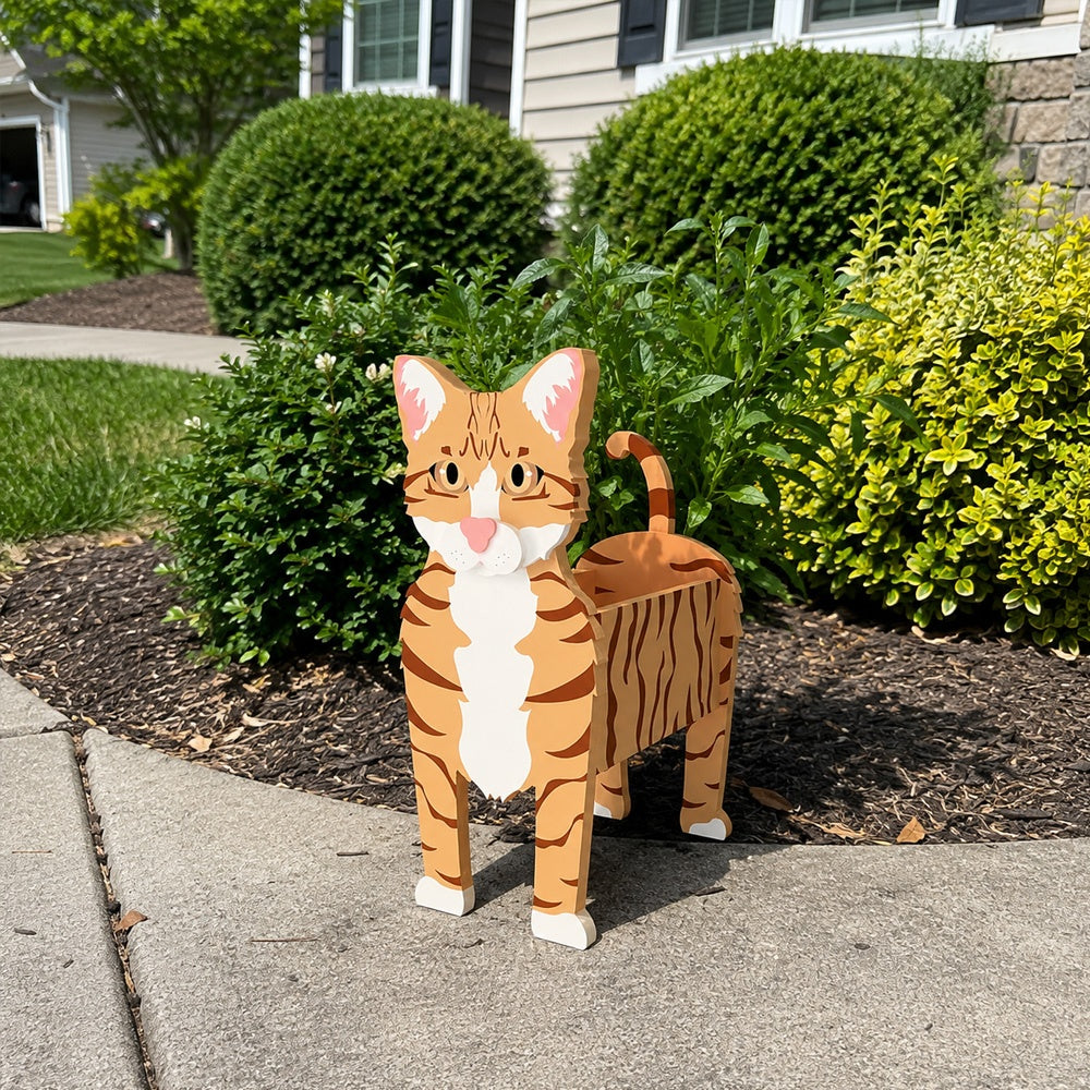 Orange Tabby cat planter filled with fresh flowers is placed in the garden