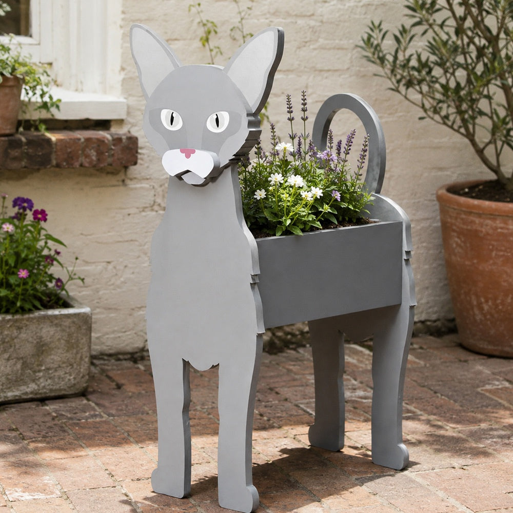 Oriental Shorthair cat planter filled with fresh flowers is placed in the garden