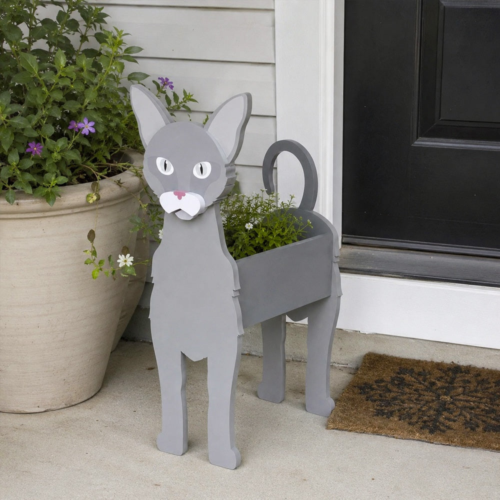 Oriental Shorthair cat planter filled with fresh flowers is placed in the garden
