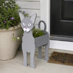 Oriental Shorthair cat planter filled with fresh flowers is placed in the garden