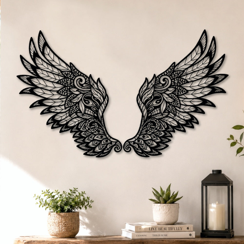 Black metal Ornate Angel wings wall art with intricate cutout details displayed on the wall