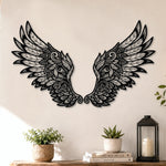Black metal Ornate Angel wings wall art with intricate cutout details displayed on the wall