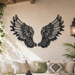 Black metal Ornate Angel wings wall art with intricate cutout details displayed on the wall
