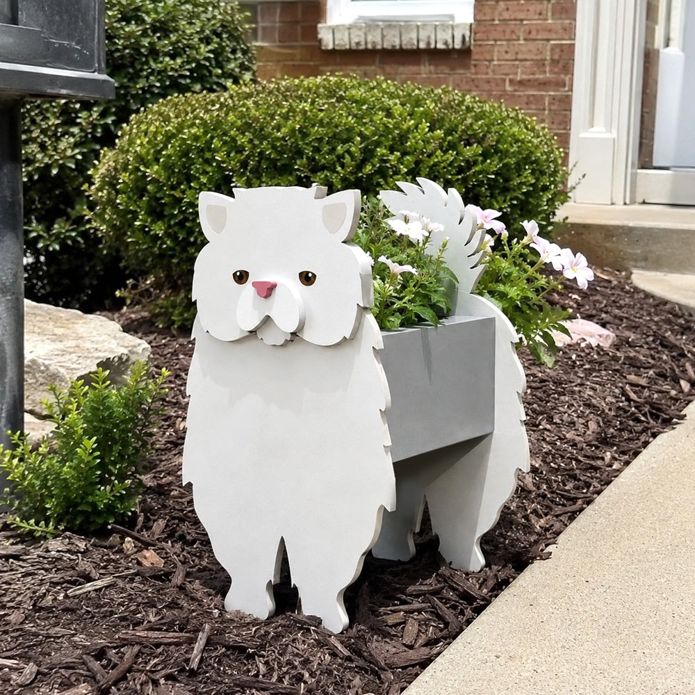 Persian cat planter filled with fresh flowers is placed in the garden