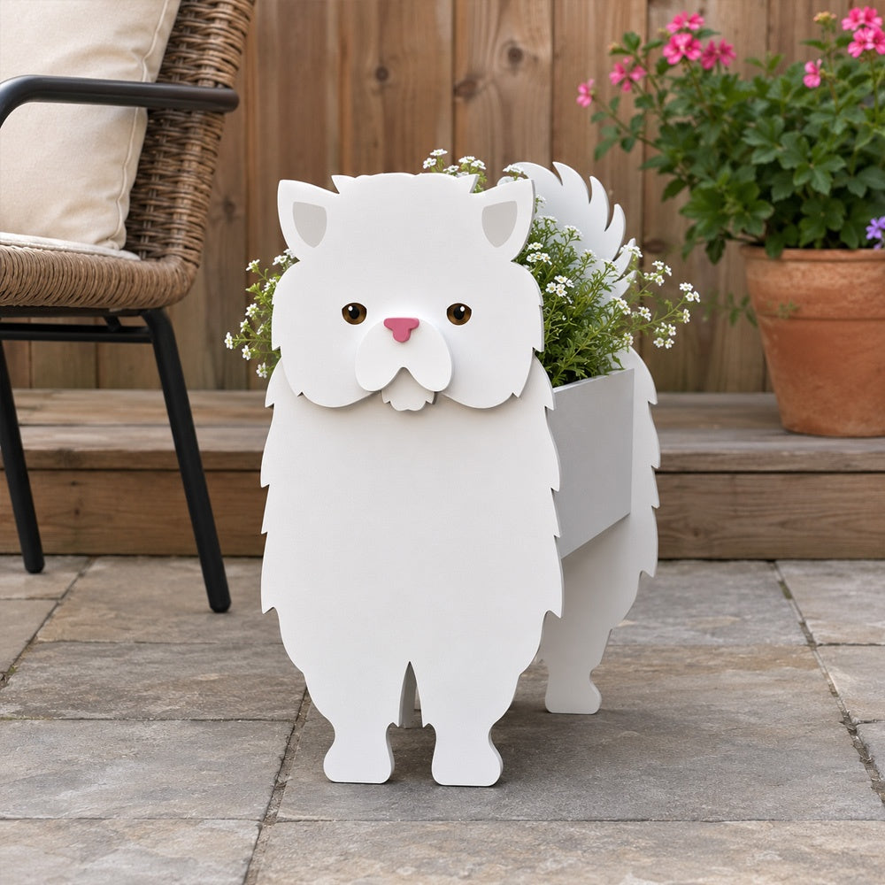 Persian cat planter filled with fresh flowers is placed in the garden