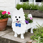 Pomeranian dog planter filled with fresh flowers is placed in the garden