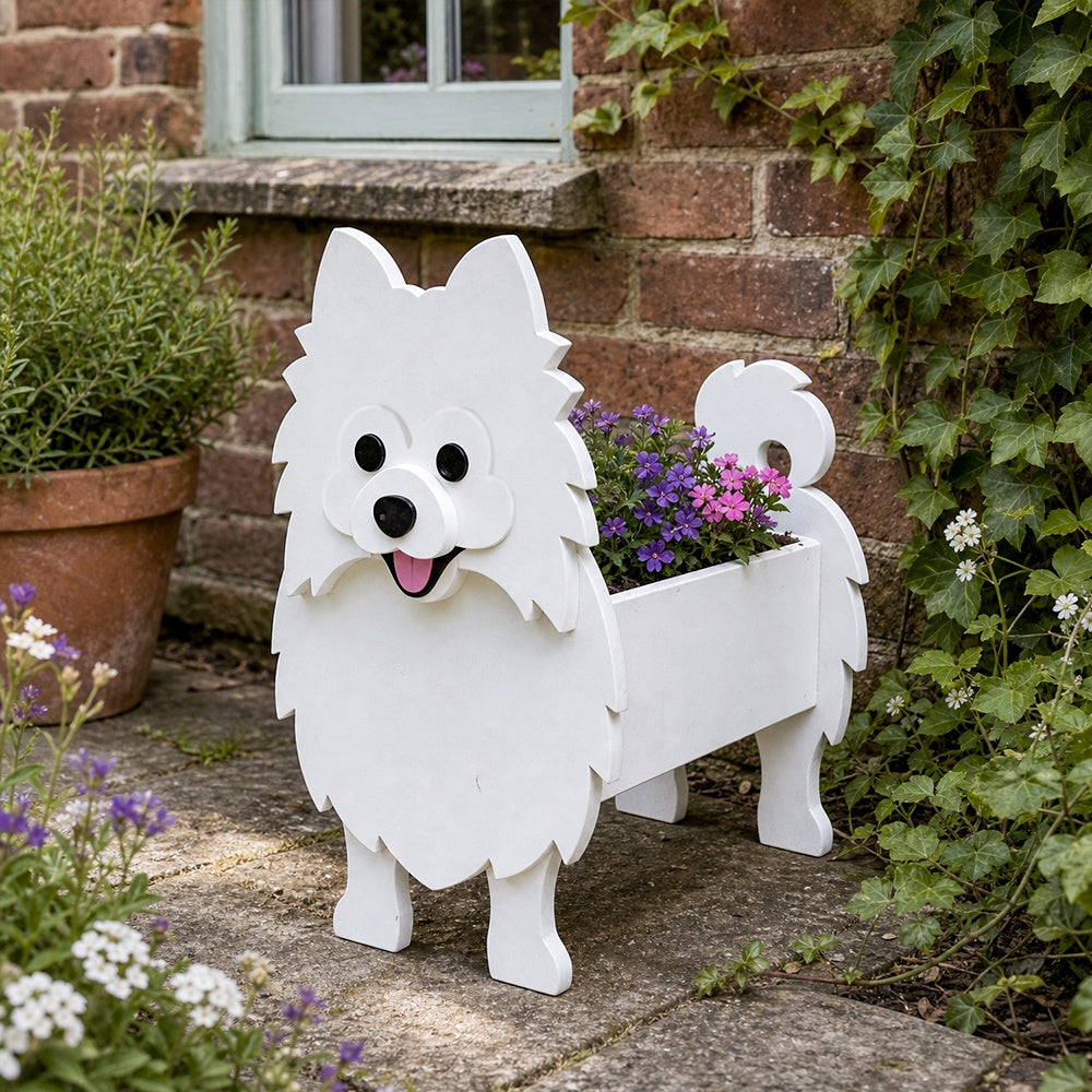 Pomeranian dog planter filled with fresh flowers is placed in the garden