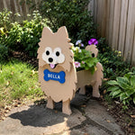 Pomeranian dog planter filled with fresh flowers is placed in the garden
