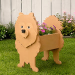 Pomeranian dog planter filled with fresh flowers is placed in the garden