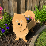 Pomeranian dog planter filled with fresh flowers is placed in the garden