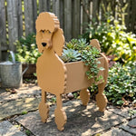 Poodle dog planter filled with fresh flowers is placed in the garden