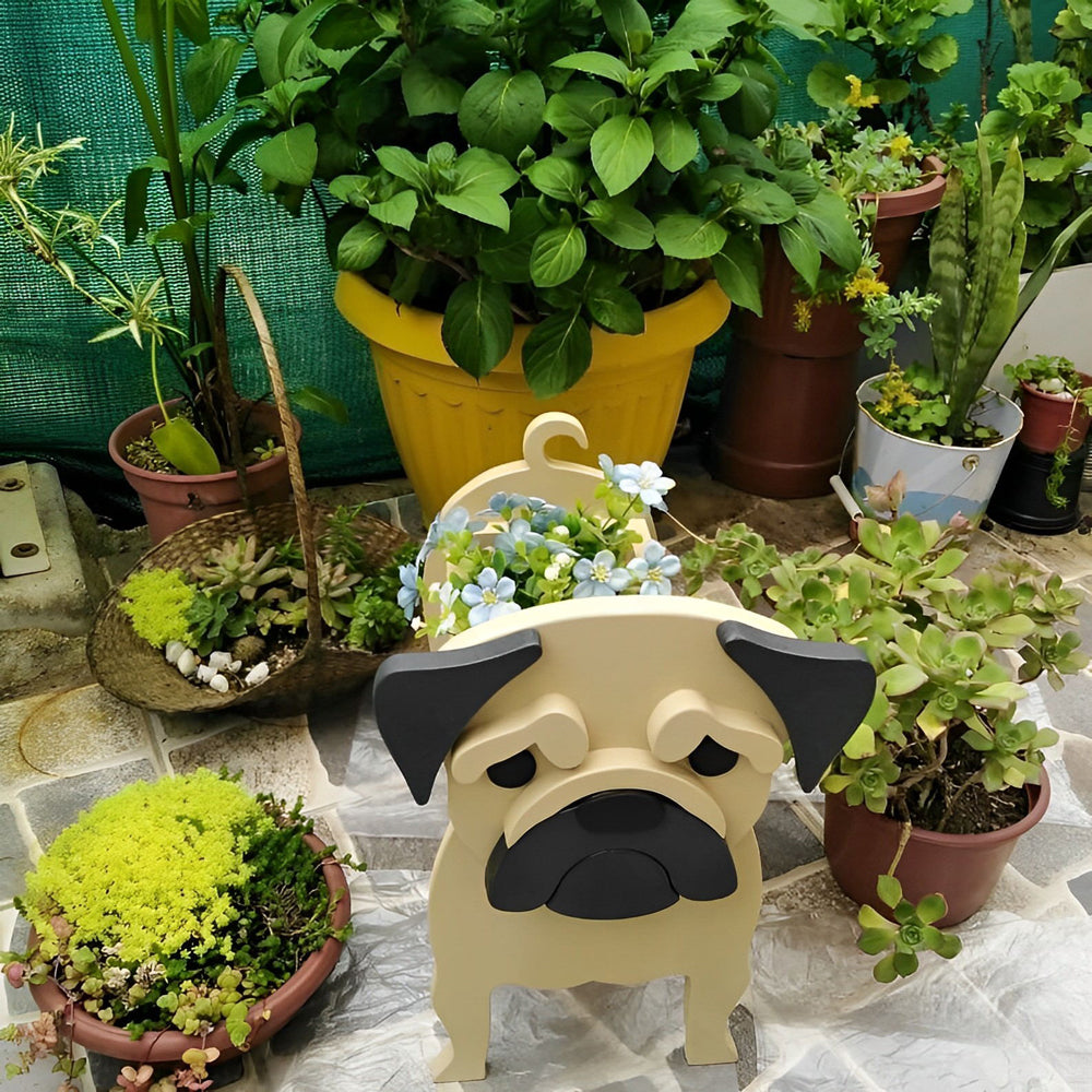 Fawn pug dog planter surrounded by various potted plants on a stone surface