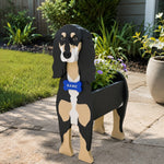Saluki dog planter filled with fresh flowers is placed in the garden