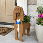 Saluki dog planter filled with fresh flowers is placed in the garden