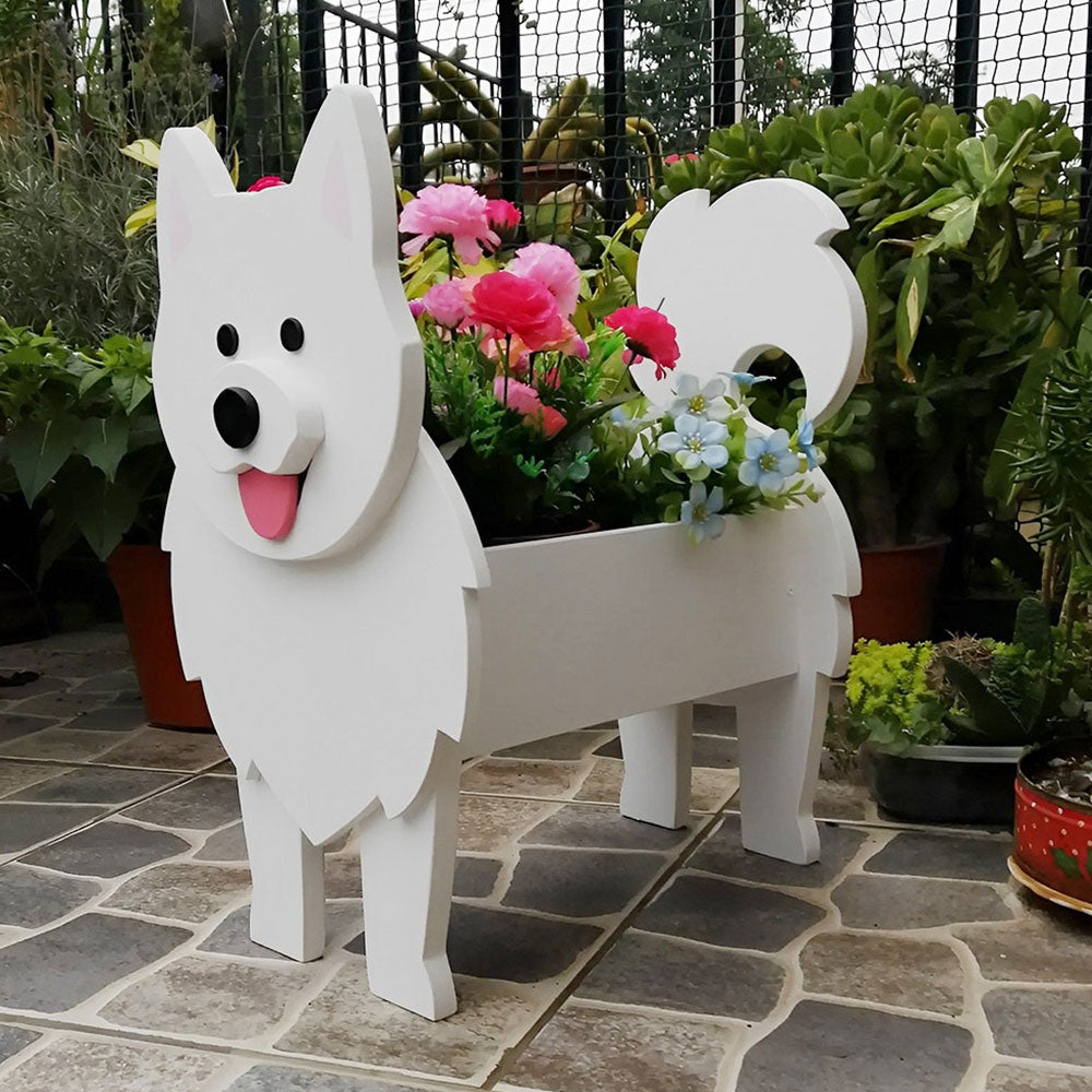 Samoyed dog planter filled with fresh flowers is placed in the garden